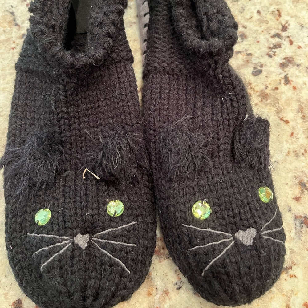 NEW. Black cat slipper socks. Knitted too with grey “suede” bottom size 7-8.